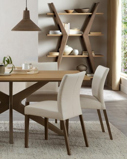 Some tables host dinners. This one hosts stories. The Kristen dining table blends oak and light weath...