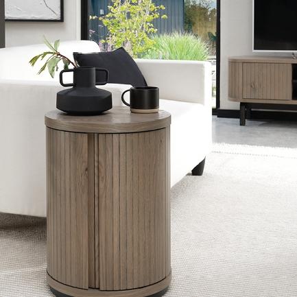 Discreet storage never looked so polished. ⁠ ⁠ Vega Grey’s round lamp table hides cables, books...